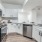 a kitchen with white cabinets