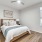 Primary bedroom with a fan and a bed