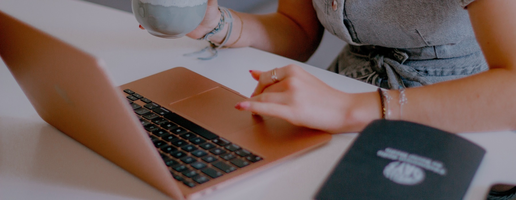 a woman with a laptop and a coffee